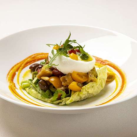 An artistically arranged plate with prawns and sauce.