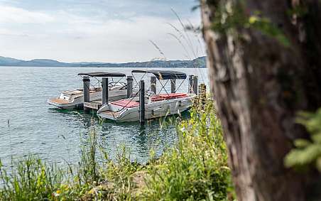 Two boats at the dock in calm waters.