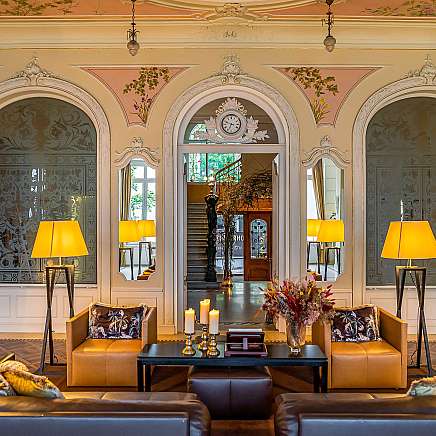 Stylish living room with sofas, lamps, and decorative elements.