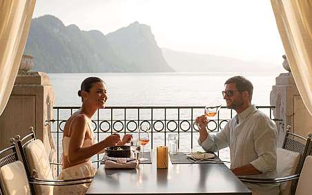 Couple enjoying dinner with a view of the lake.