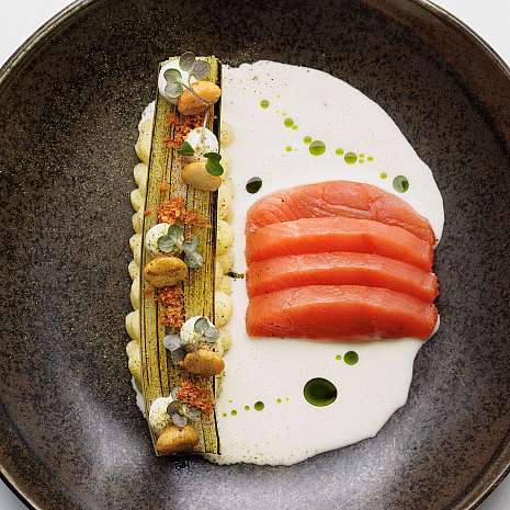 An artistically arranged plate with salmon and sides.